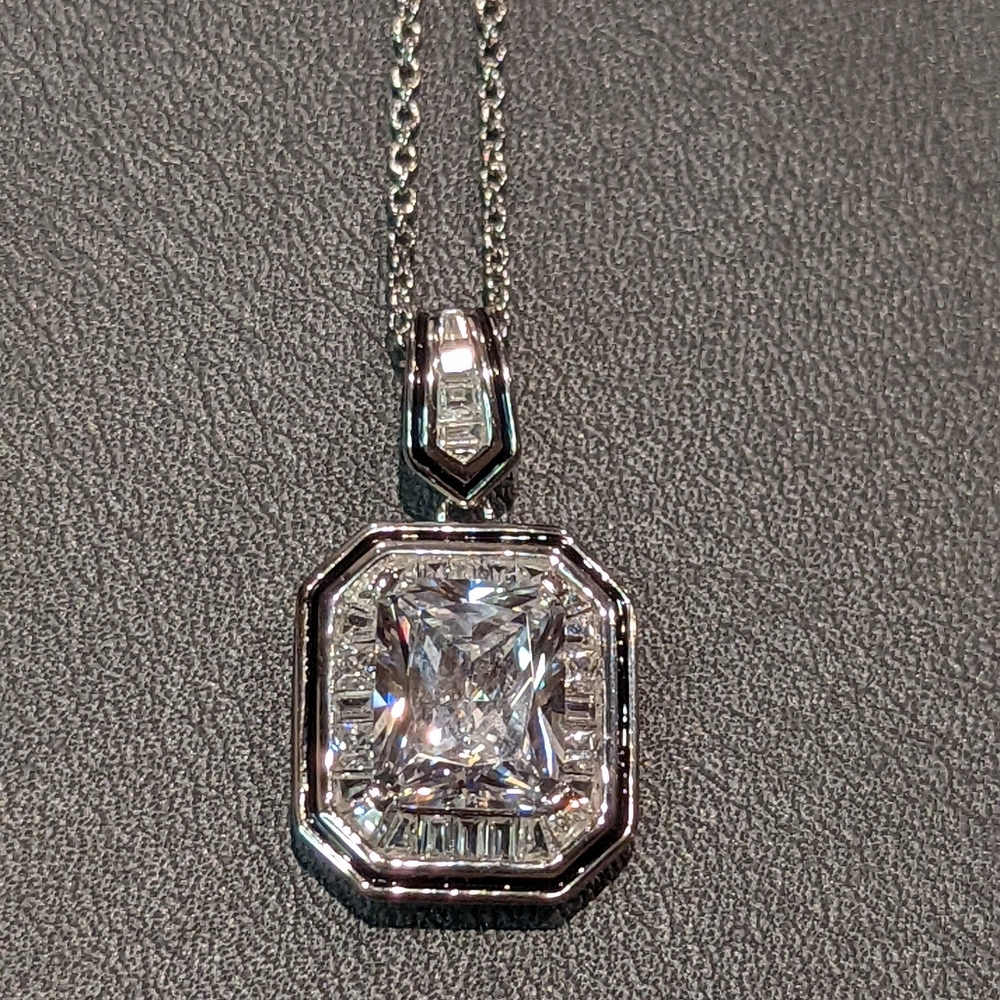Radiant cut CZ with baguette halo and enamel pendant necklace.